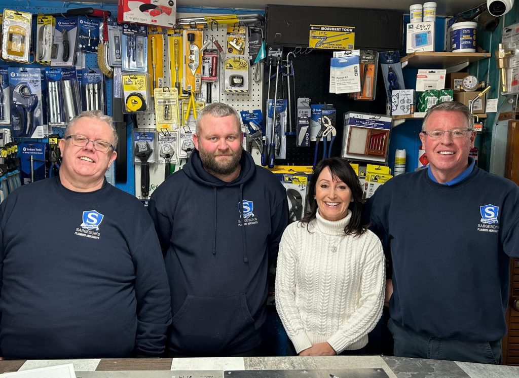The friendly team at Sargeson’s Plumbers Merchants in Blackpool, standing inside their local plumbing and heating supplies shop, stocked with tools, boiler parts and trade essentials for customers across the Fylde Coast.